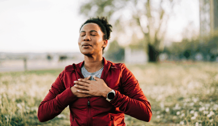 an older woman practices meditation and mindfulness exercises outside