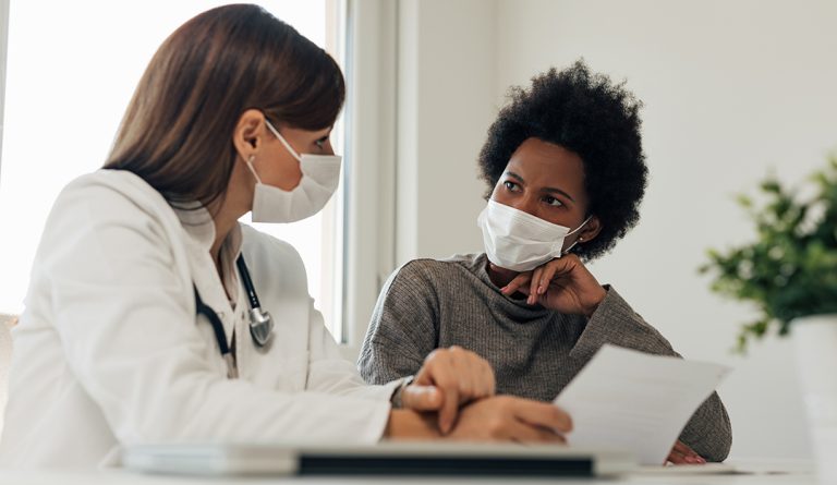 a black woman talks to her doctor