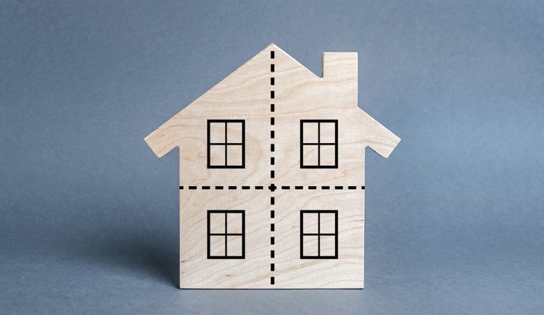 photo of a wooden house with lines to divide it into fourths to represent estate planning