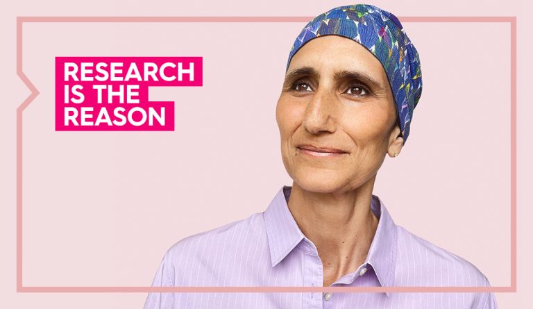 pam wears a headscarf and a purple shirt and smiles looking away from camera with the words research is the reason next to her