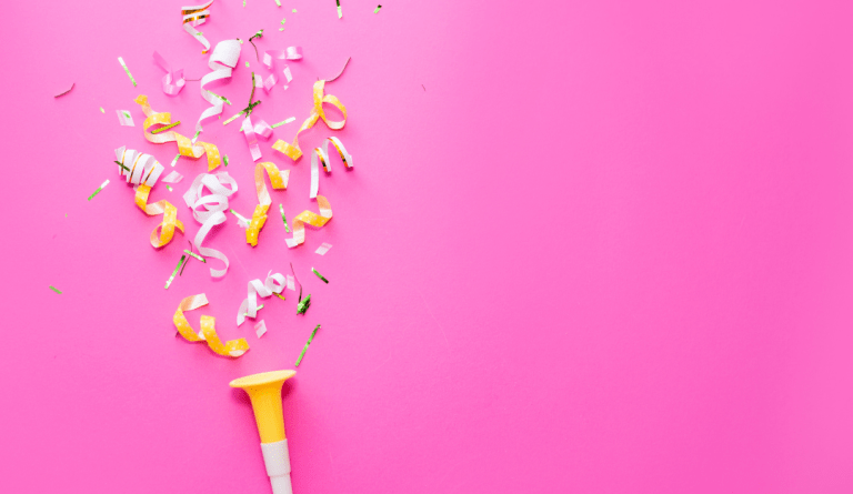 yellow and white confetti on a pink background