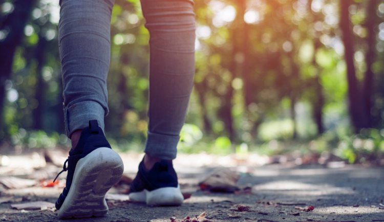 a shot of a woman walking showing her legs and sneakers