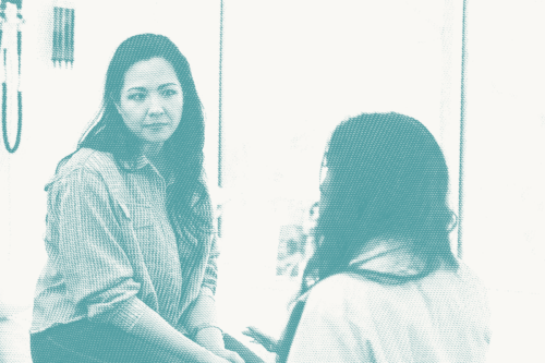 a woman speaks with her doctor, she has a concerned expression