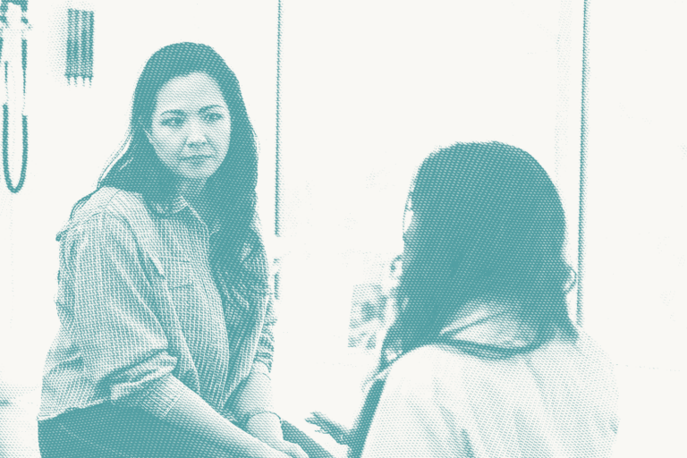 a woman speaks with her doctor, she has a concerned expression