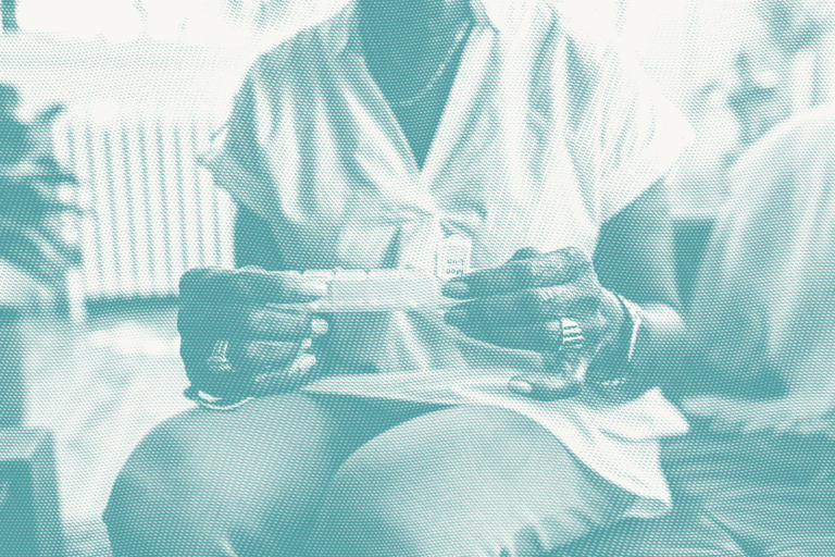 an older woman looks at a pill organizer to take hormone therapy for breast cancer