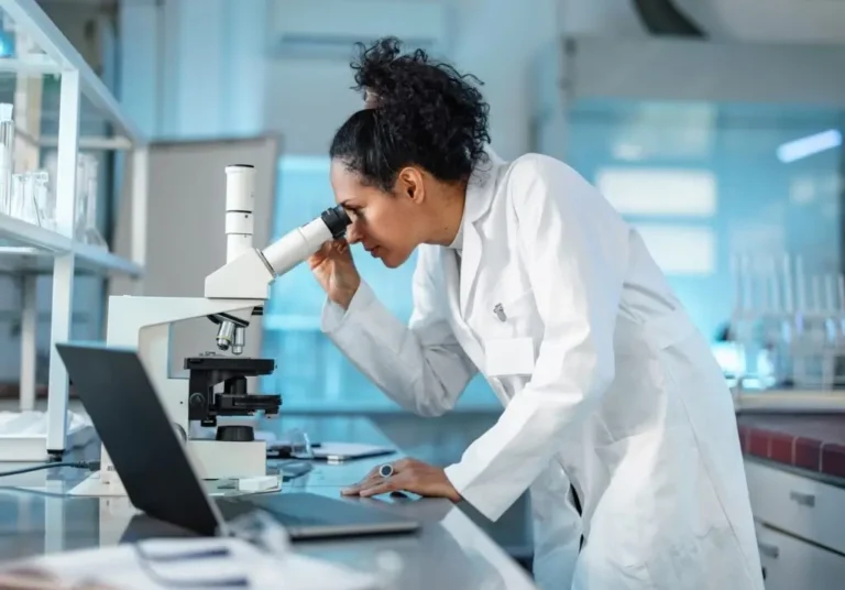 Female scientist looking in a microscope