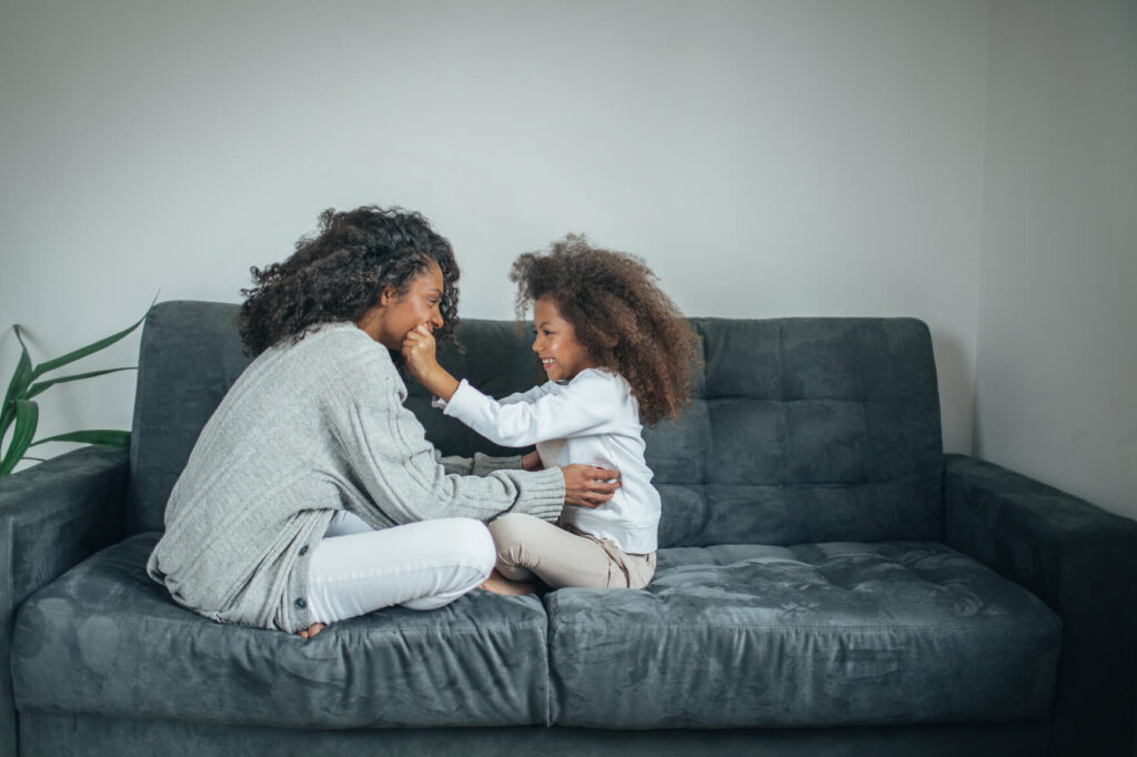 A young woman playing with her daughter