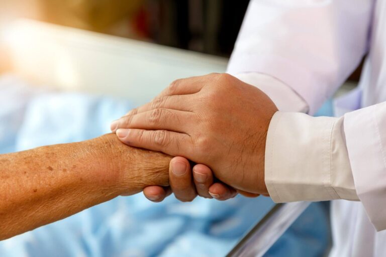Doctor holding patient's hand