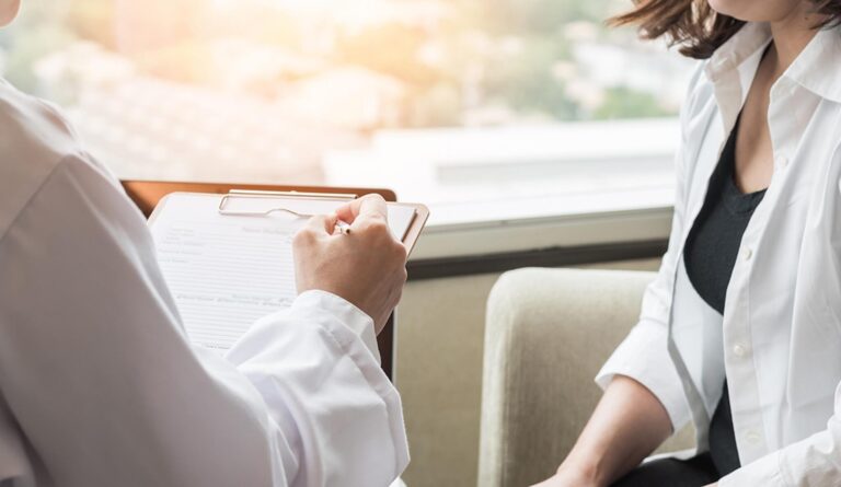 A woman talks to her doctor