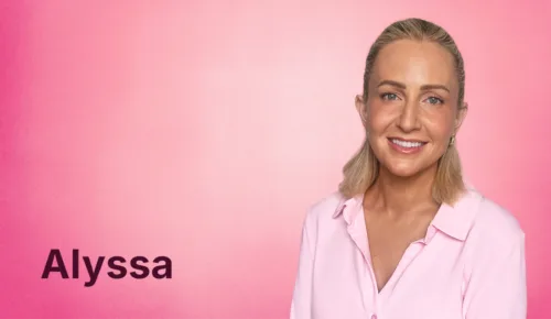 Alyssa Butts smiling at the camera in front of a pink background and her name