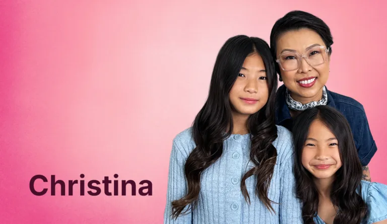 Christina Thammeson in a blue shirt with two of her daughters in light blue sweaters