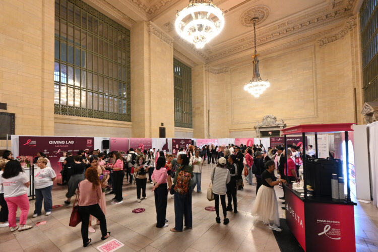 A crowd gathers at grand central terminal to commemorate the start of breast cancer awareness month