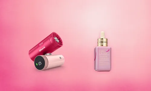 pink products in front of a pink background: shark fan and estee lauder companies serum